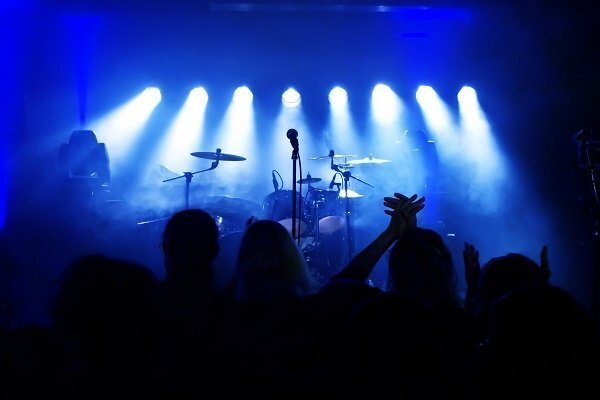 band on stage with blue lights